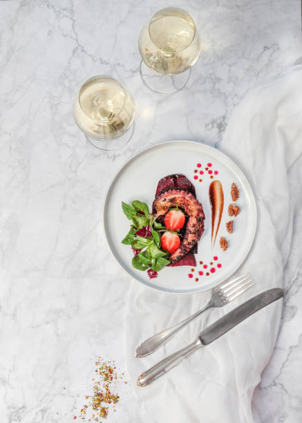 Elegant Seafood Appetizer Plate with Grilled Octopus Beetroot Carpaccio and White Wine Elegant Seafood Appetizer Plate with Grilled Octopus Beetroot Carpaccio and White Wine food styling stock pictures, royalty-free photos & images