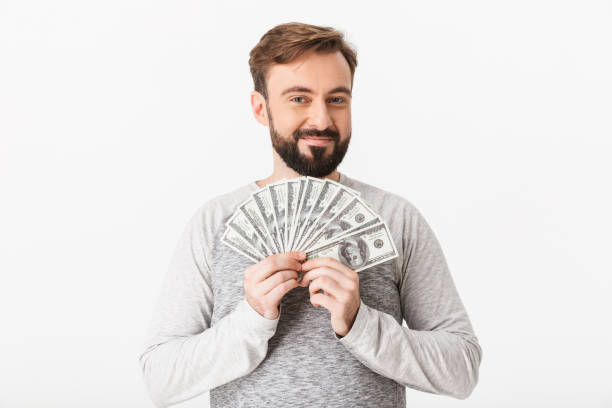 istock Happy young man holding money. Looking camera. 1289412616