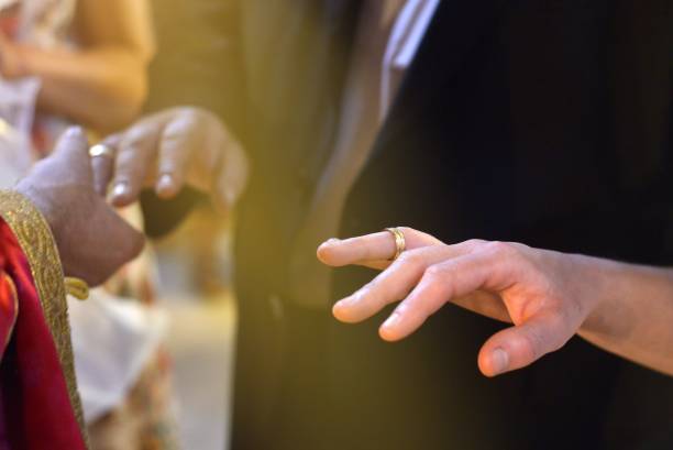 istock Priest is putting the ring on bride's finger during orthodox wedding ceremony 1289414020