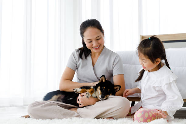 istock Mother and daughter with their dog. 1289414749