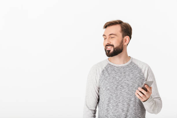 istock Handsome young man chatting by mobile phone looking aside. 1289415381