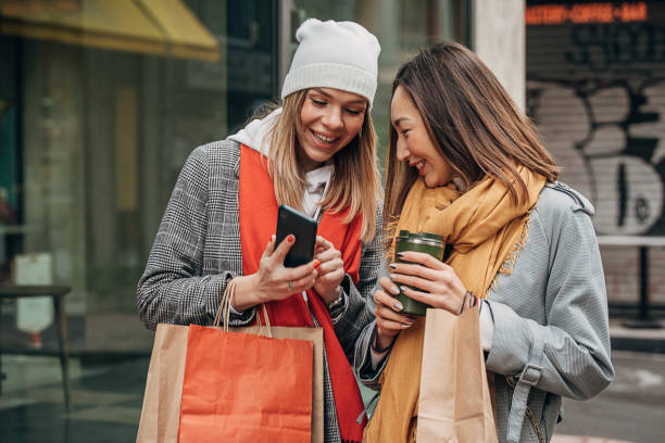 istock Modern women using smart phone on the street 1289415449