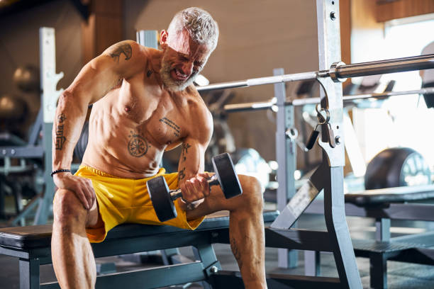 istock Strong athletic man performing the bicep curl 1289415710