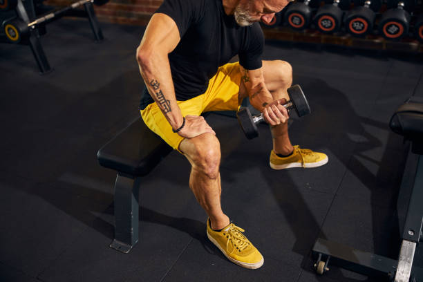 istock Focused athlete doing the seated dumbbell curl 1289415811