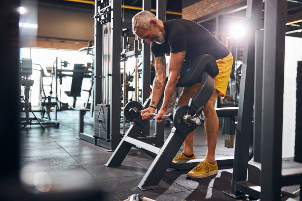 istock Joyous sporty man building up his biceps 1289415821