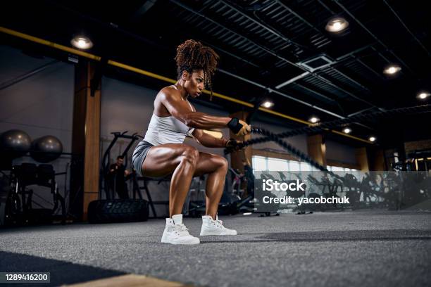 Athletic Woman Doing The Fullbody Cardio Workout Stock Photo - Download Image Now - Exercising, Gym, Women