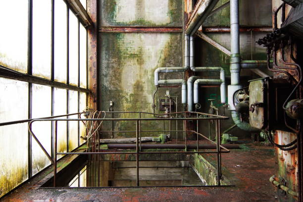 abandoned factory lost place old paper mill goes back to nature, moss on walls and rust on pipes abandoned place stock pictures, royalty-free photos & images