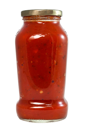Isolated glass jar of spaghetti sauce.