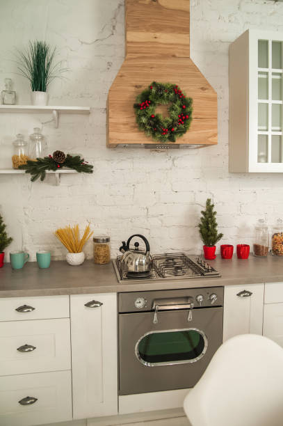 istock New Year's decor of modern kitchen in Scandinavian style. White light rustic kitchen close-up and copy space. Hygge kitchen details New year concept. Selective focus 1289417208