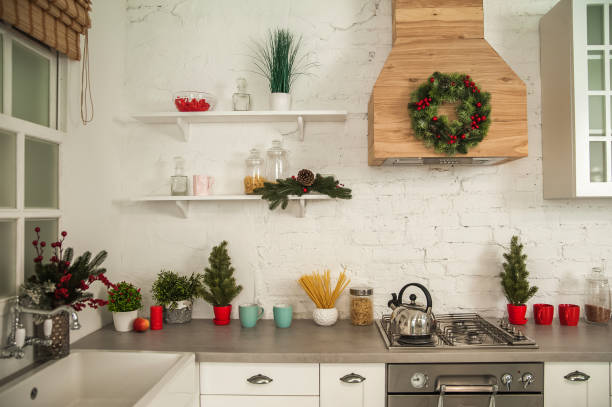 istock New Year's decor of modern kitchen in Scandinavian style. White light rustic kitchen close-up and copy space. Hygge kitchen details New year concept. Selective focus 1289417240