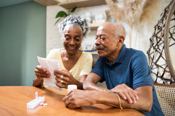 Senior adult taking medication at home Senior adult taking medication medicare stock pictures, royalty-free photos & images