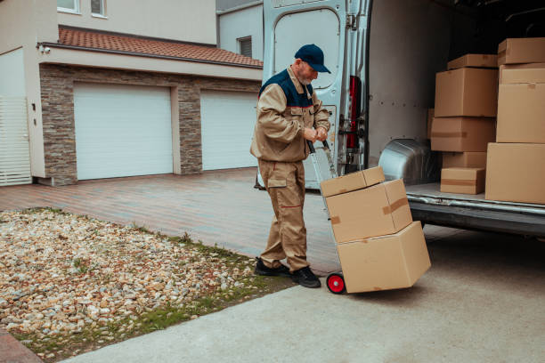 istock Delivery man packing cardboard boxes in van 1289418523