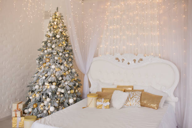 istock A spacious white light bedroom with a decorated Christmas tree and a garland. New Year interior 1289418534