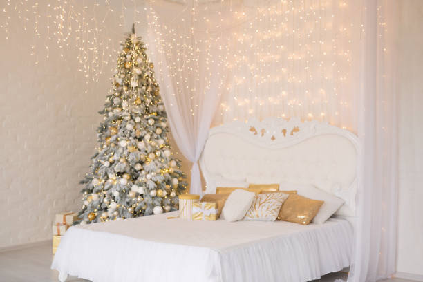 istock A spacious white light bedroom with a decorated Christmas tree and a garland. New Year interior 1289418606