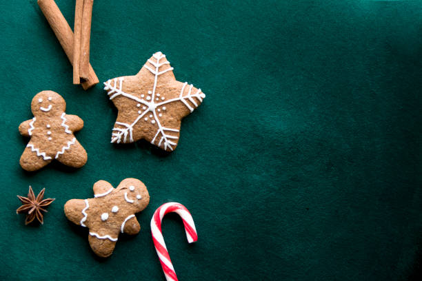 istock Green background with gingerbread men and snowflakes 1289419303