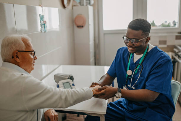 istock Senior man treated by young doctor at home 1289420070