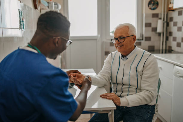istock Senior man treated by young doctor at home 1289420156