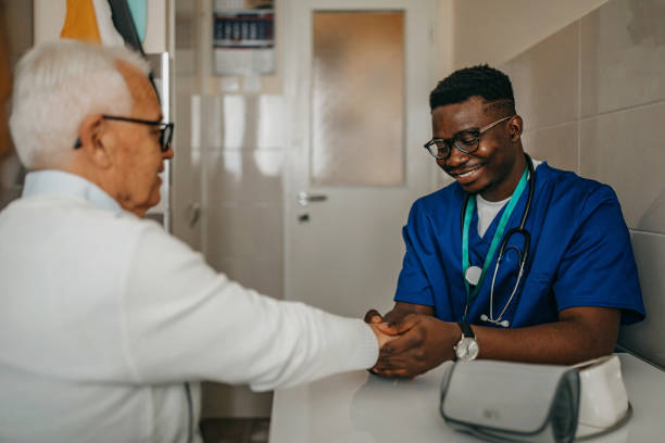 istock Senior man treated by young doctor at home 1289420176
