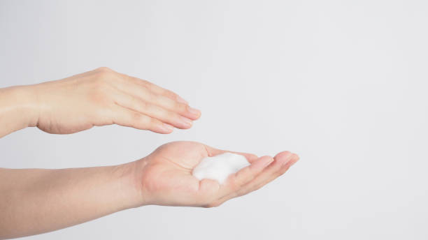istock Hand washing gesture with foaming hand soap on white background 1289420491