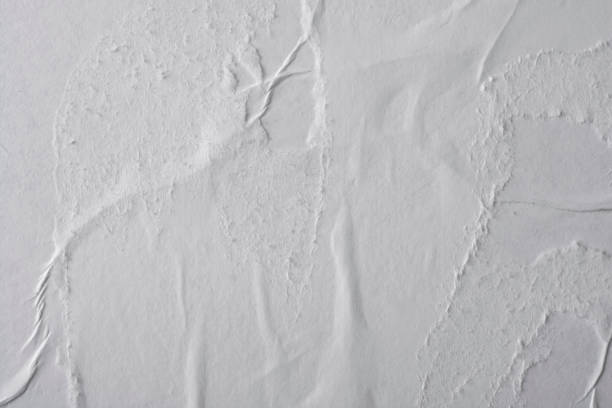 istock Crumpled white paper. Blank street poster texture. 1289421344