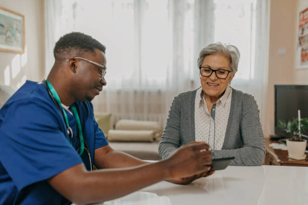 istock Senior woman treated by young doctor 1289421928