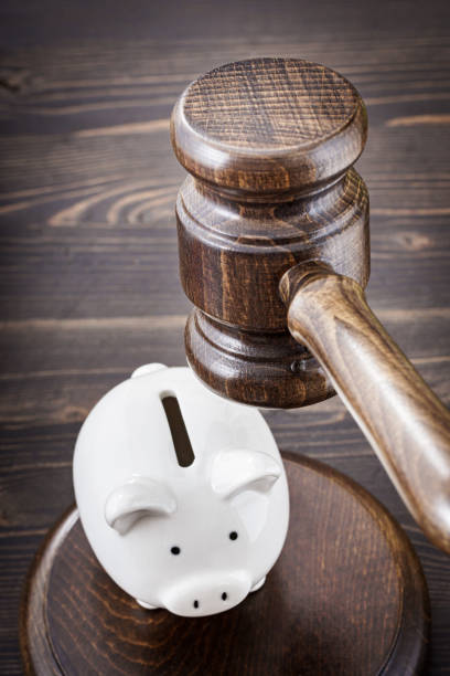 istock Gavel under small piggy bank 1289423478