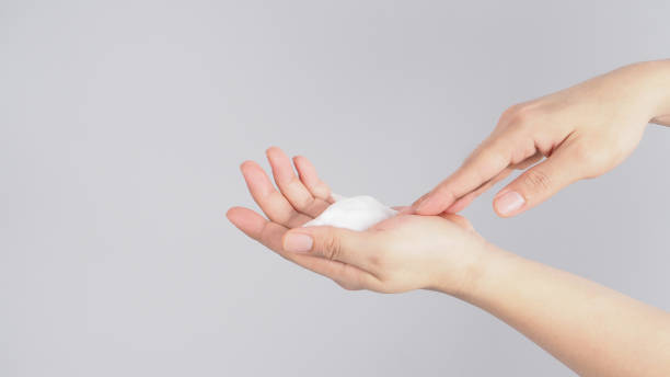 istock Hands washing gesture with foaming hand soap on white background. 1289423795