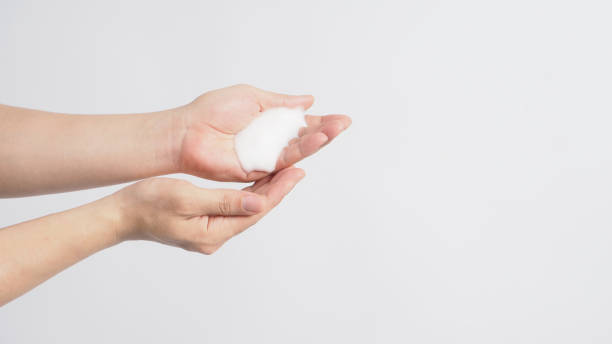 istock Hands washing gesture with foaming hand soap on white background. 1289423823