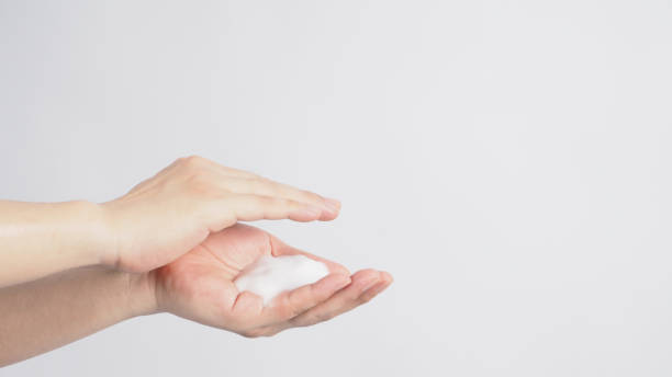 istock Hands washing gesture with foaming hand soap on white background. 1289424036