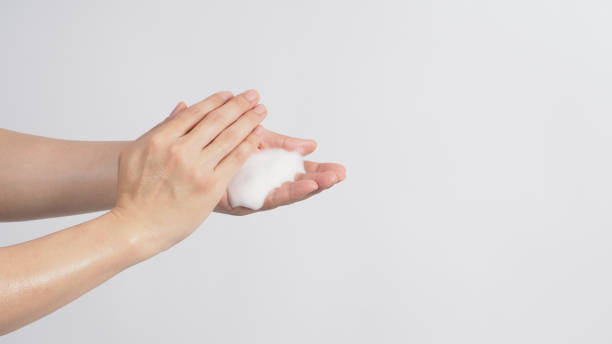 istock Hands washing gesture with foaming hand soap on white background. 1289424042