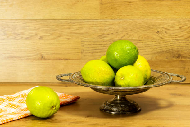 istock green fresh lemon on antique plate 1289424944