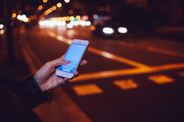 istock Faceless woman messaging on phone in evening city 1289425511