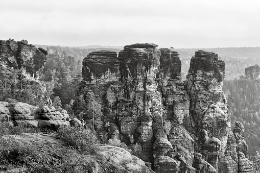 panoramic view at rockformations in Saxon Sandstone Mountains taken from famous viewpoint Bastei in Saxony