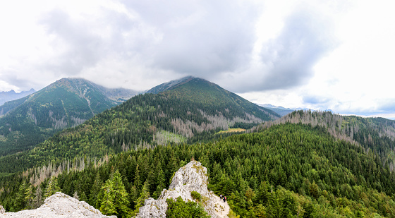 Landscape of Tatra Mountains seen from Gesia Szyja Peak, with Turnia nad Dziadem and Mala Koszysta peaks in the clouds.