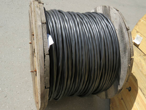 istock Electric power copper cable in black insulation on a wooden coil 1289428830