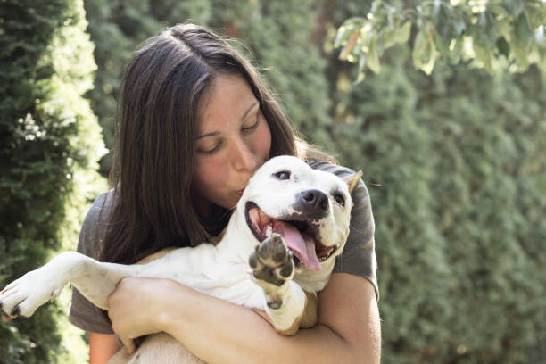 istock Young woman kissing her dog 1289430062