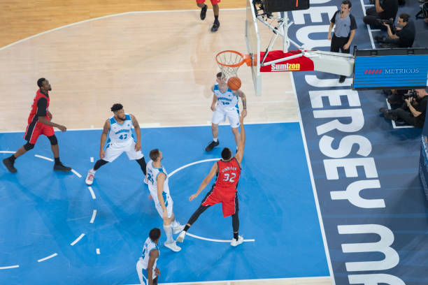 istock Basketball player throwing a ball to the hoop 1289431113