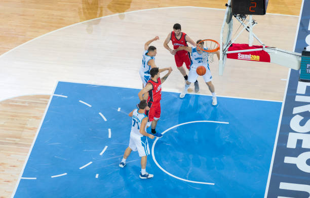 istock Basketball players chasing for ball 1289431133