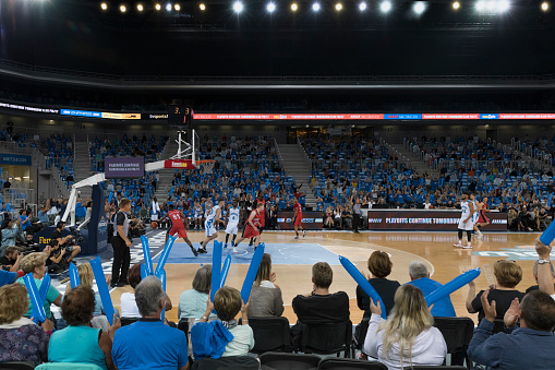 Basketball players playing during match in court.