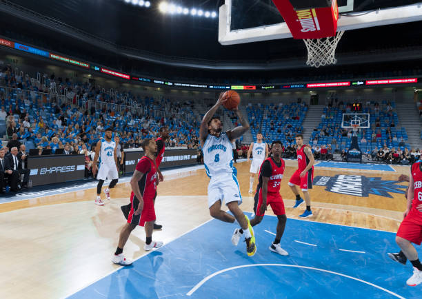 istock Basketball player jumping to score slam dunk 1289431183