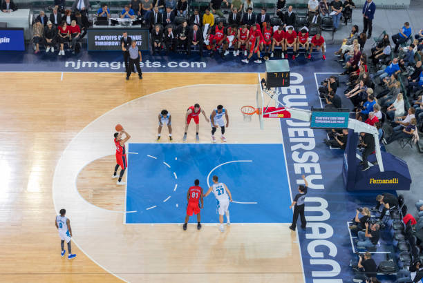 istock Basketball player throwing a ball to the hoop 1289431268