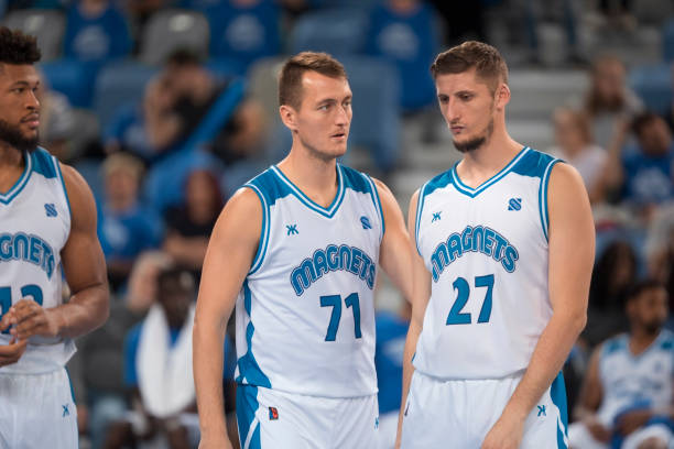 istock Basketball players standing in court 1289431277