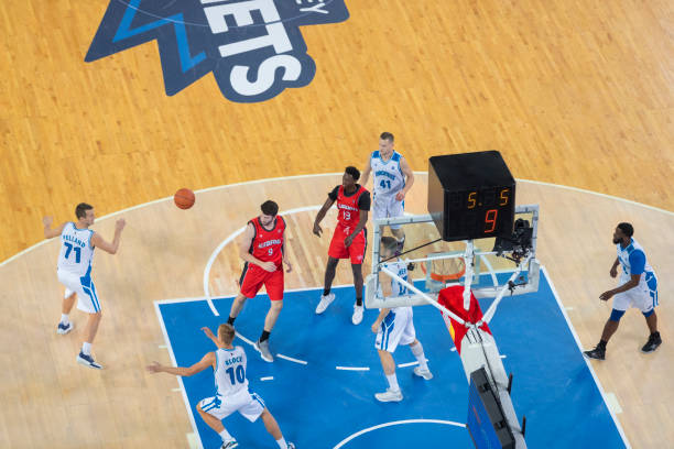 istock Basketball players playing in court 1289431279