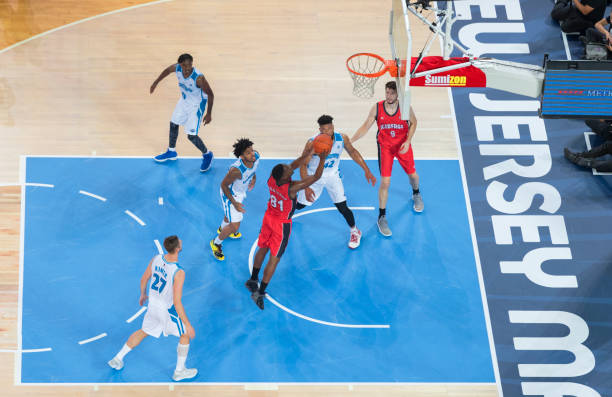 istock Basketball player jumping to score slam dunk 1289431294
