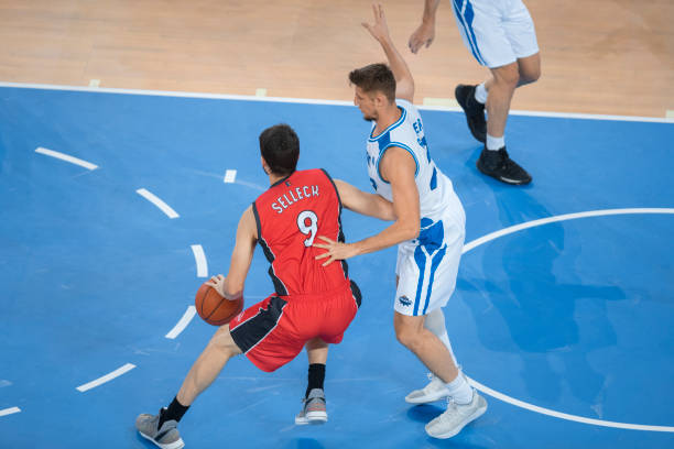 istock Basketball player dribbling ball 1289431297