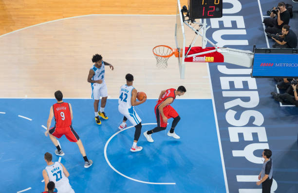 istock Basketball players chasing for ball 1289431310