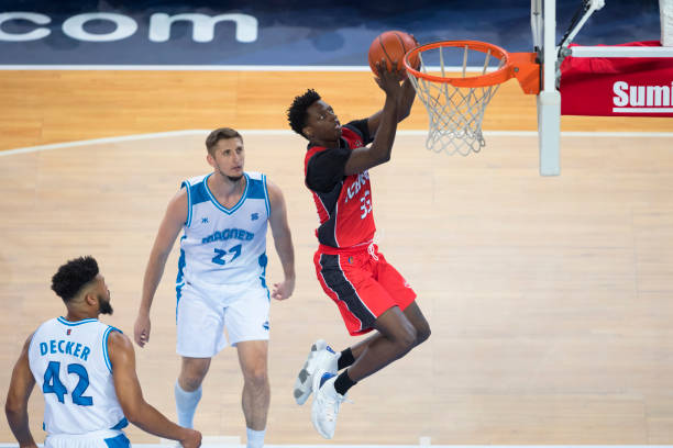 istock Basketball player jumping to score slam dunk 1289431311