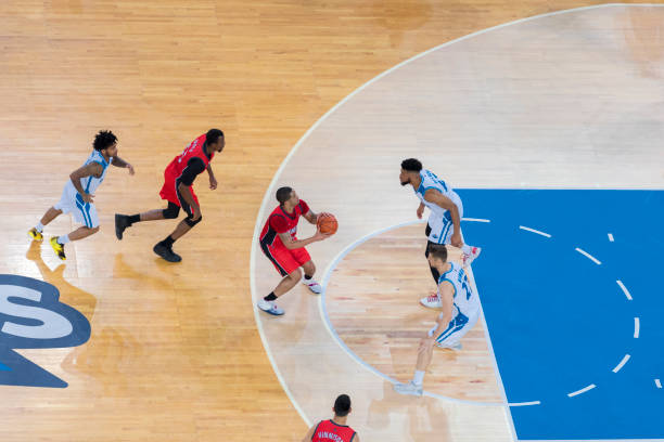 istock Basketball players chasing for ball 1289431336