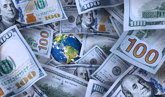Conceptual business and finance image of large group of American one hundred dollar bills. \nNASA world image layered and used; https://apod.nasa.gov/apod/image/0304/bluemarble2k_big.jpg