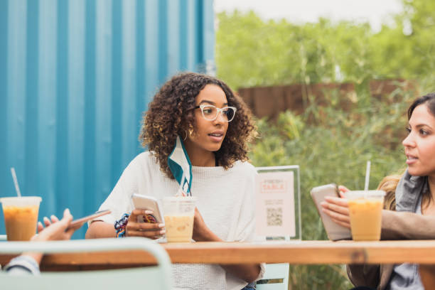 istock Female friends enjoy iced drinks and conversation during coronavirus outbreak 1289432993
